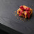 Best selling red ribbon on a blondie on a dark charcoal table top.