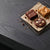 Brownie, blondie, and cookie, fresh out the oven, on a dark charcoal table top.